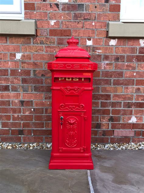 red metal post box|red free standing post box.